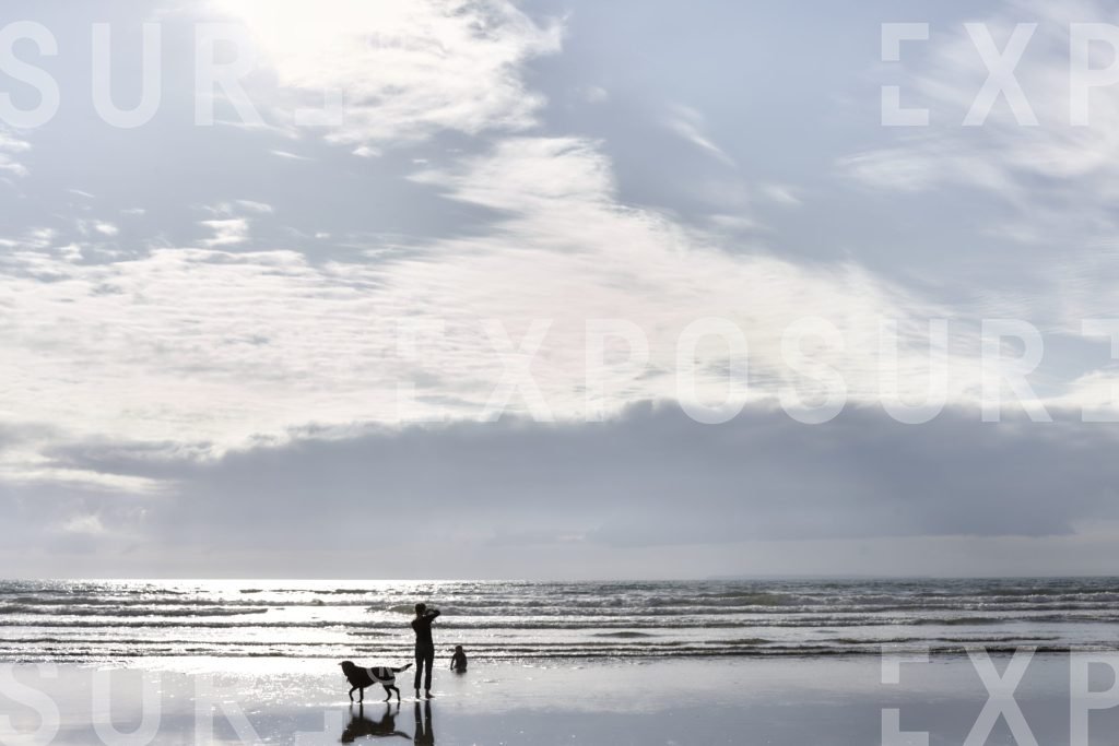 Family playing on deserted beach