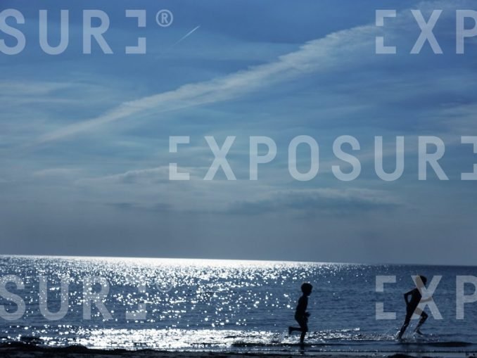 Running Boys On The Seashore in Denmark