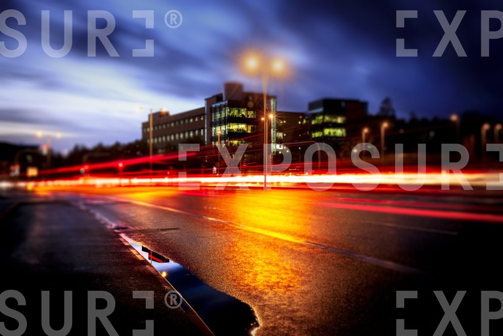 Corporate Building And Reflection In City At Night