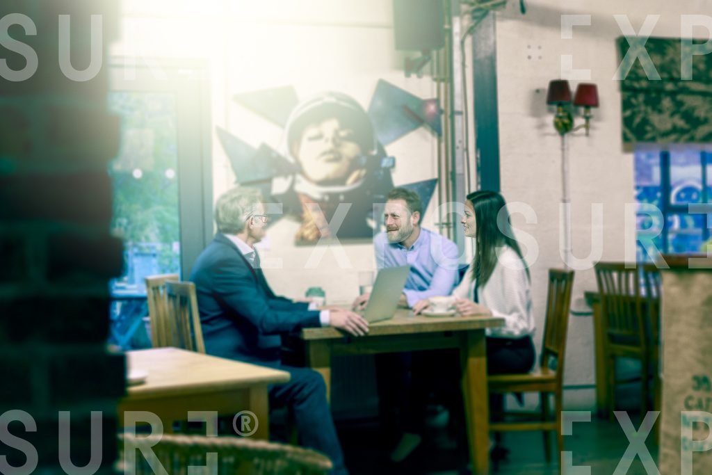 People Having Meeting In Cafe