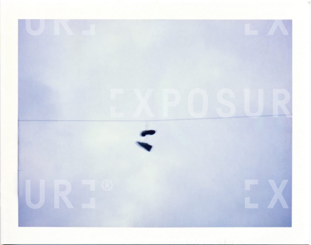 Training shoes on a telephone wire
