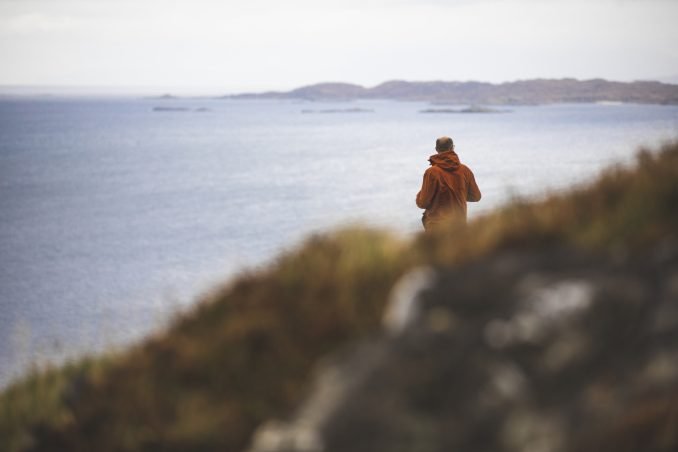 Man looking out onto the landscape in the Highlands of Scotland