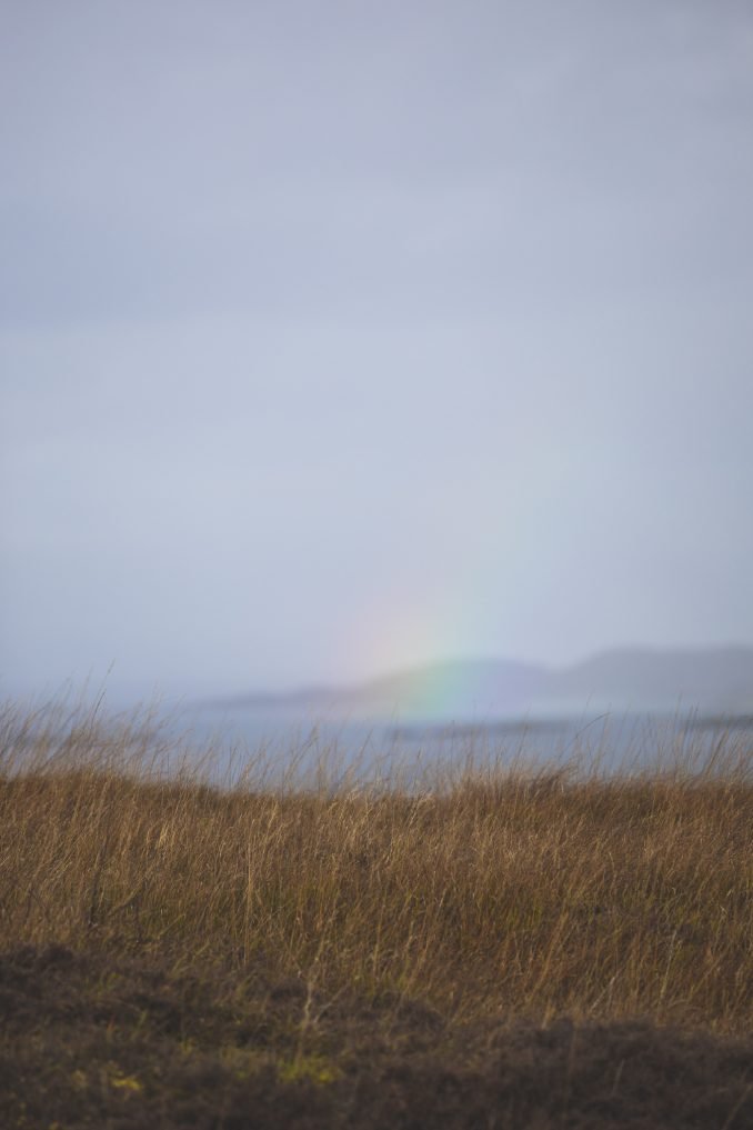A patch of rainbow on the horizon in the Highlands of Scotland