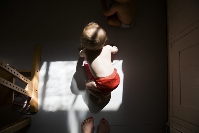 Twin crawling in morning light