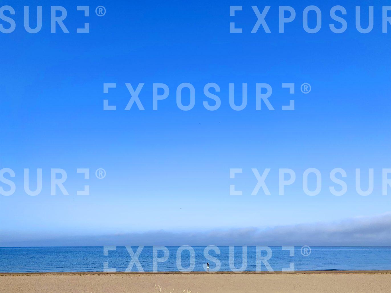 Lady on a Scottish beach in the summer