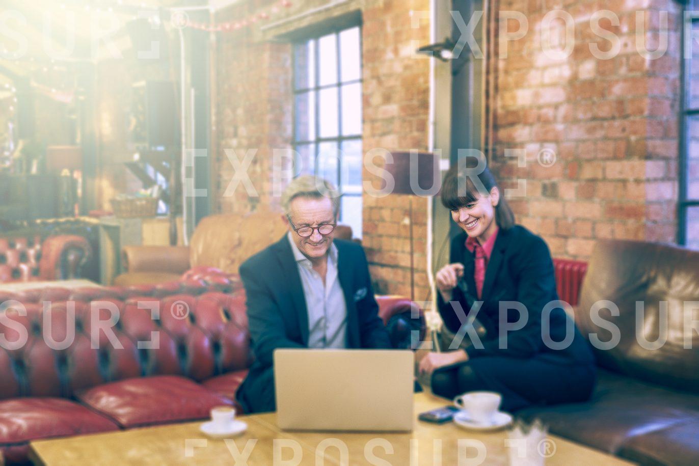 Male And Female Working In Cafe