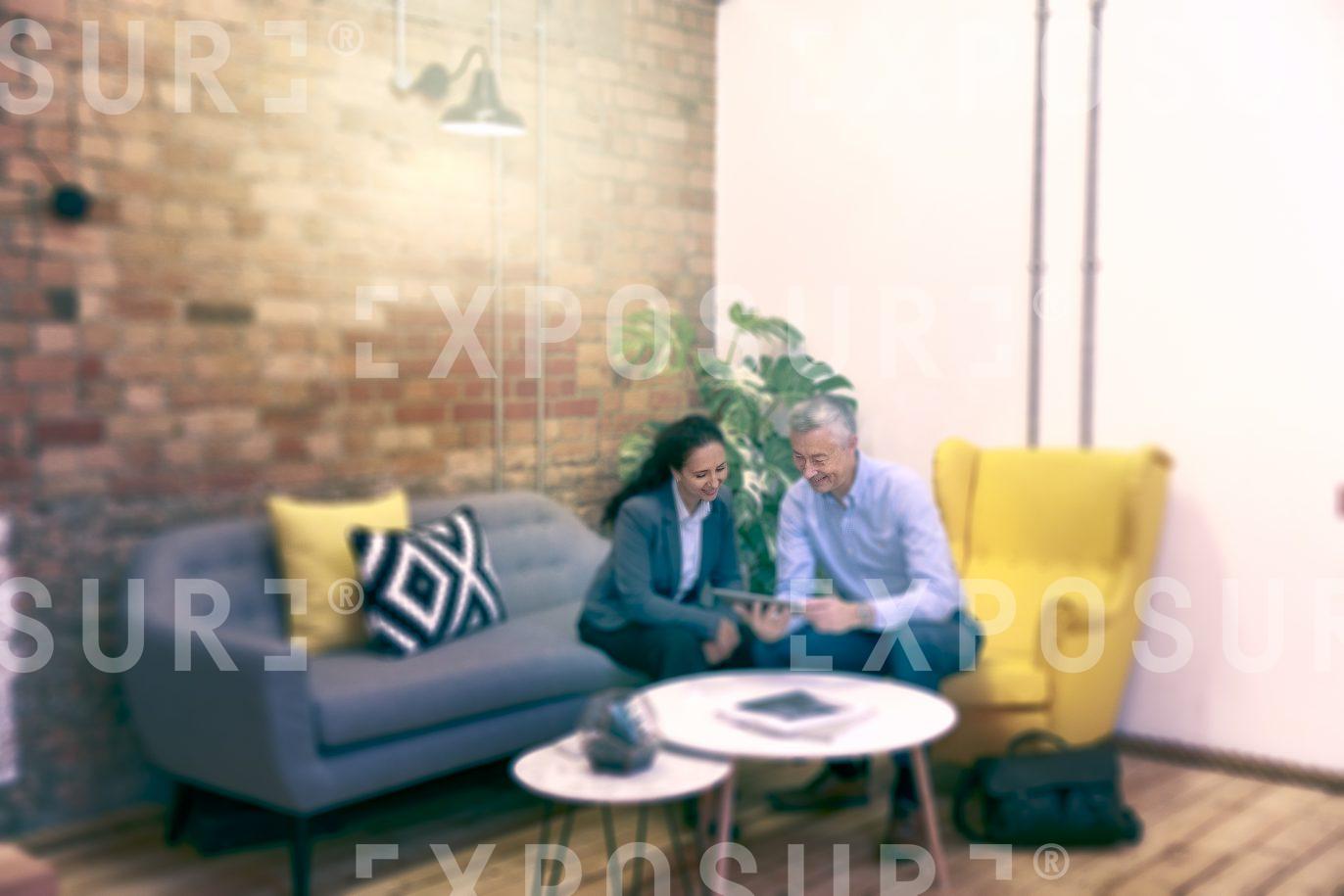 Couple Sat In Reception Area For Informal Meeting