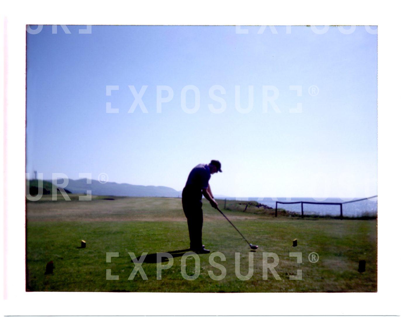 Polaroid of a man playing golf