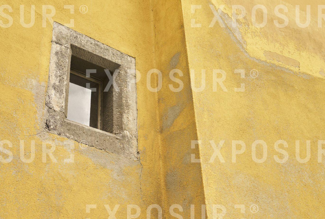 Small window in yellow wall