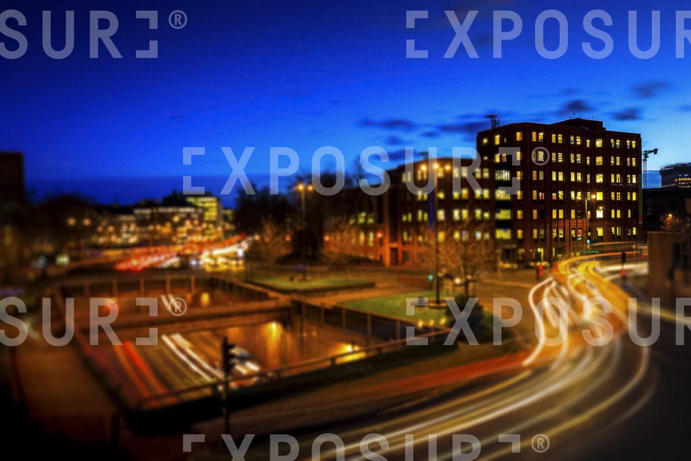 Elevated View Of City Roads and Corporate Buildings In City At Night