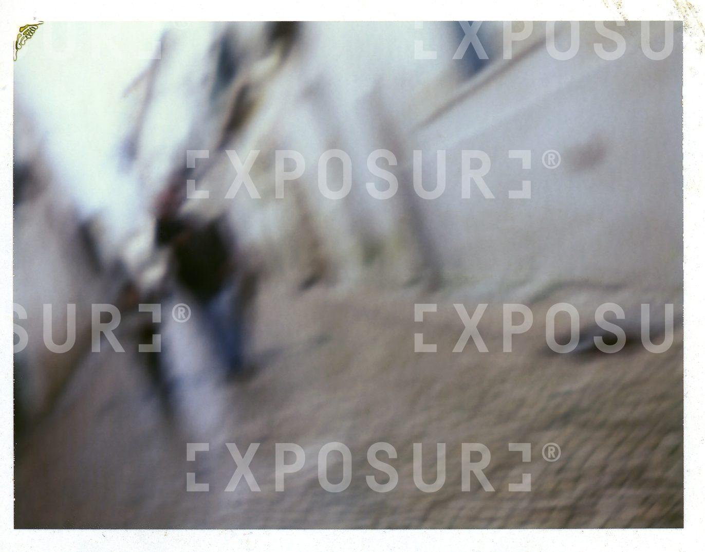 A visually impaired man and boy in a Spanish street
