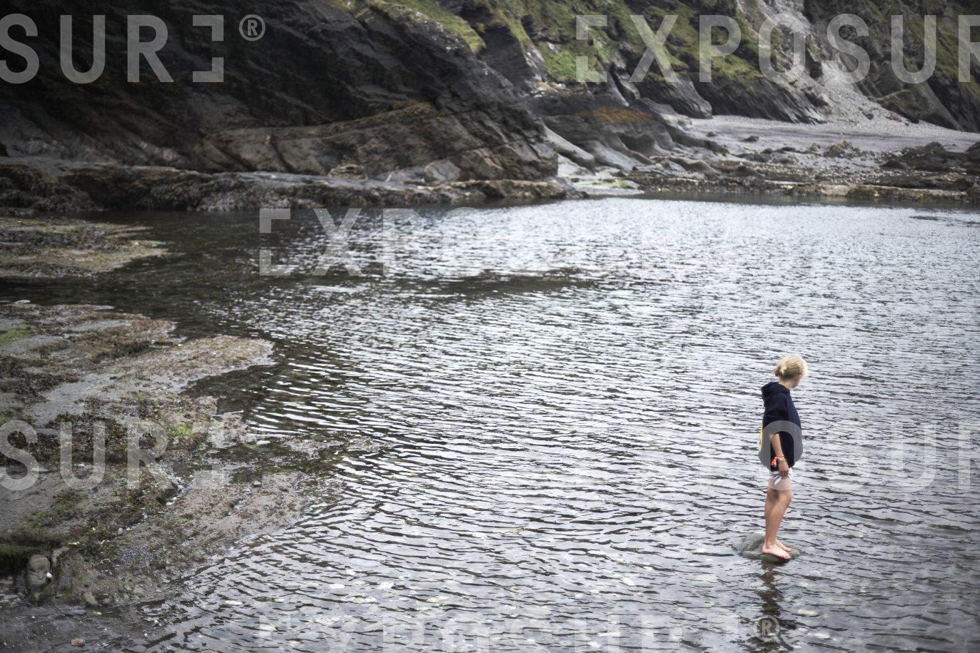 Young girl in rock pool, Devon