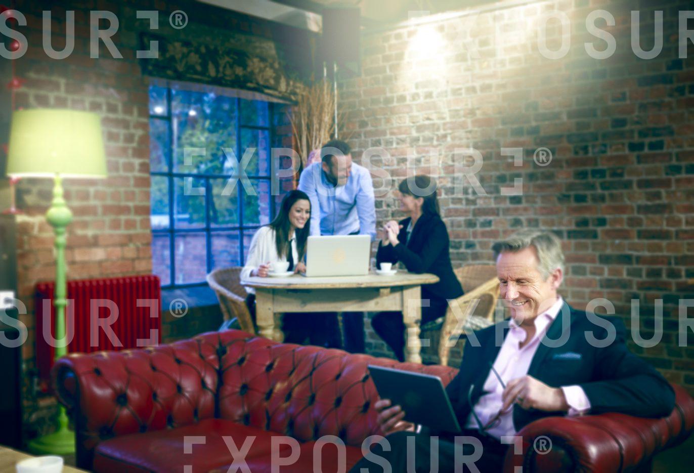 Group Remote Working In Cafe