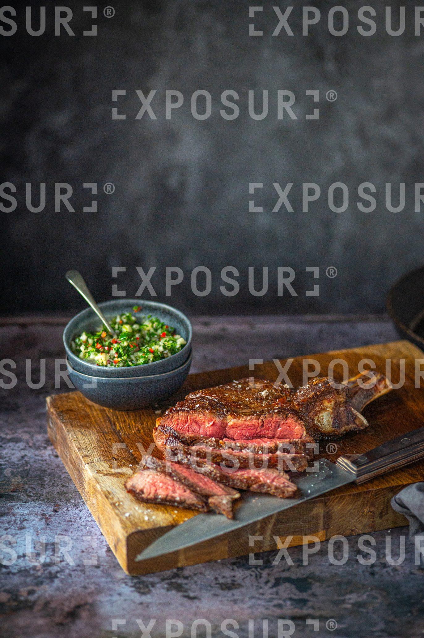 Medium-rare steak and chimichurri sauce